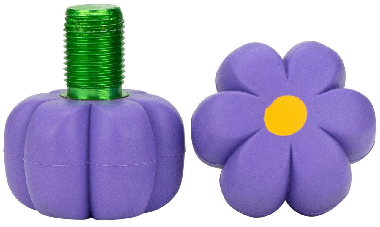 The left object features a green threaded bolt, making it perfect for roller skates, while the right is a six-petal cap with a yellow center. Both resemble Moxi Brake Petal Roller Skate Toe Stops in Violet by Moxi, offering versatility and durability that could easily be mistaken for high-quality toe stops.