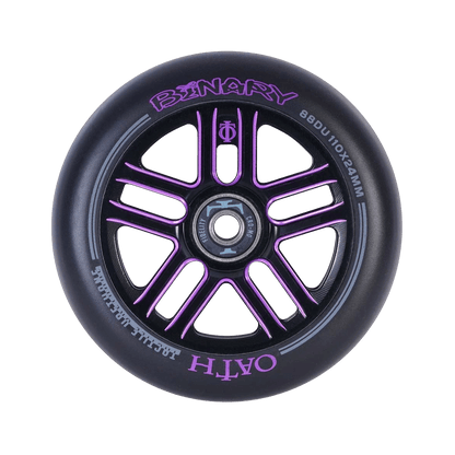 A close-up of the Oath Binary 110mm Stunt Scooter Wheel in Black and Purple highlights its purple metallic spoke design with advanced lightweight hollow-core wheel technology. The words "BINARY" and "OATH" are inscribed on the rim, alongside specifications "88DU 110x24MM," featuring premium Oath Fidelity bearings for smooth performance.