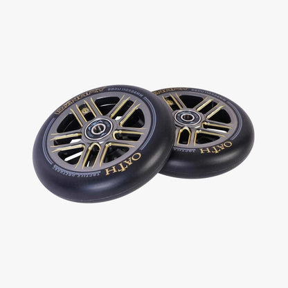 A pair of Oath Binary 110mm Stunt Scooter Wheels in a striking black design with gold accents and visible spokes, prominently showcasing branding text on the outer rims. Renowned for their impact resistance and durability, these wheels are stacked on top of each other against a plain white background.