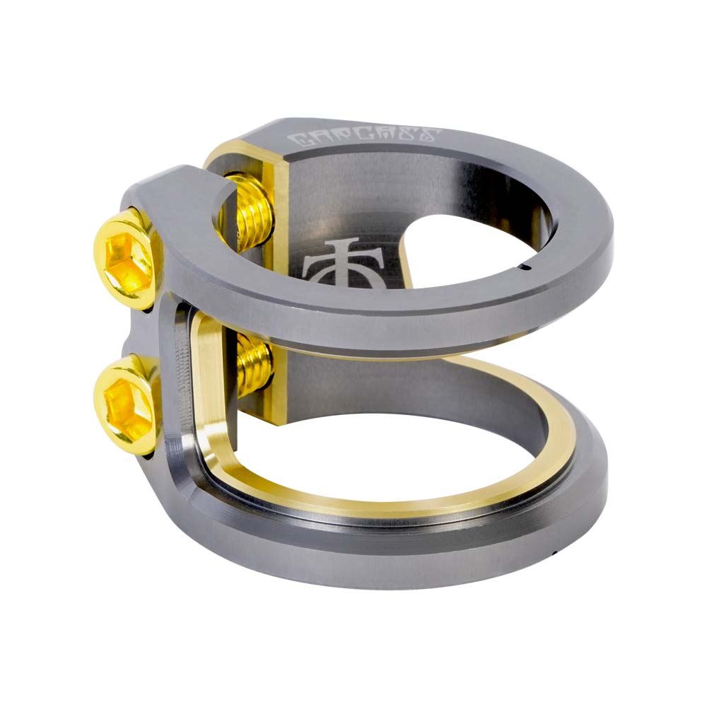 The Oath Carcass 2 Bolt Oversized Stunt Scooter Clamp by Oath is a stylish clamp made from 6061 T6 Aluminium with titanium and gold finishes. It features two golden bolts and engraved markings, making it an ideal choice for securing handlebars on a lightweight scooter.