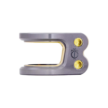 The Oath Carcass 2 Bolt Oversized Stunt Scooter Clamp in Titanium/Gold is expertly crafted from 6061 T6 Aluminum, featuring a durable side-opening design. It includes two gold screws and an engraved logo, making it ideal for securely fastening lightweight scooter components.