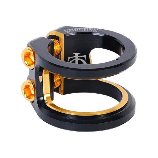 The Oath Carcass 2 Bolt Oversized Stunt Scooter Clamp in Black and Orange features a sleek design crafted from ultra-light 6061 T6 Aluminium. It includes two circular rings, striking golden hex bolt fasteners, and an engraved logo on the side for an elegant finish.