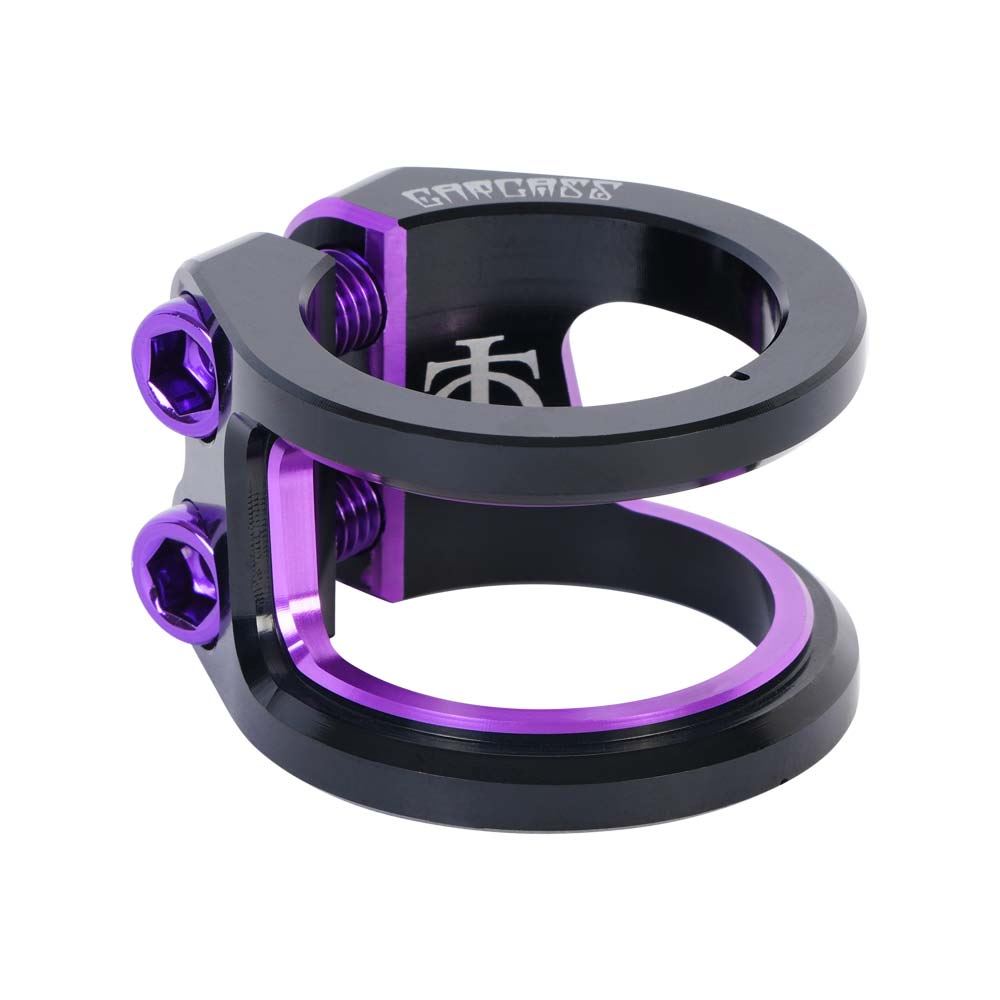 A close-up of the Oath Carcass 2 Bolt Oversized Stunt Scooter Clamp in black and purple, crafted from 6061 T6 Aluminum. It features a sleek double-bolt design with two purple hex bolts and an engraved logo. The cylindrical construction securely holds tubes or poles, while the glossy metal finish enhances the appeal of this lightweight scooter clamp by Oath.