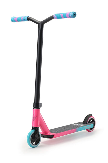 The Blunt Envy ONE S3 is a stylish pink and teal complete stunt scooter, ideal for beginner riders. It showcases vibrant grip handles, a striking blue front wheel paired with a sleek black rear wheel, all contrasting beautifully against a crisp white deck. Designed for both style and performance by Blunt Envy.