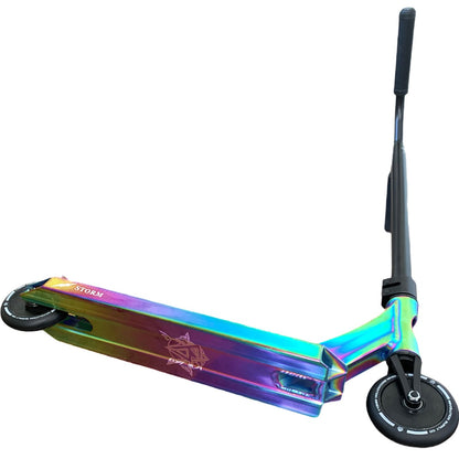 The Revolution Storm Complete Stunt Scooter - Neochrome by Revolution boasts a vibrant, iridescent design, featuring black handlebars and hollow core wheels. Its storm deck showcases a star pattern on a white background.