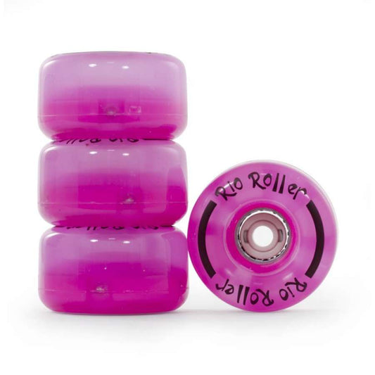 Four vibrant "Pink Frost" quad skate wheels by Rio Roller are stacked vertically, with one wheel leaning casually against the others. The glossy surface proudly displays the "Rio Roller" brand name, and they showcase visible bearings.