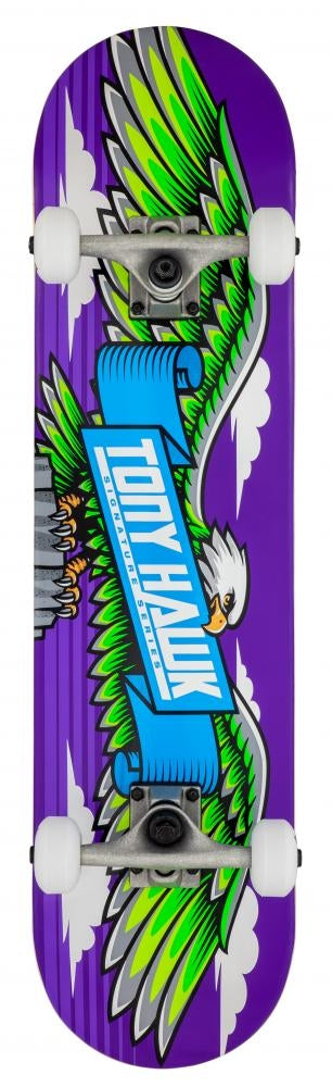 The Tony Hawk 180 Series Wingspan Complete Skateboard, sized at 7.75" x 31", showcases a striking green and white eagle clutching a blue banner emblazoned with "TONY HAWK". Its durable 7-ply maple deck features a purple background with cloud motifs, finished off with stylish white wheels.