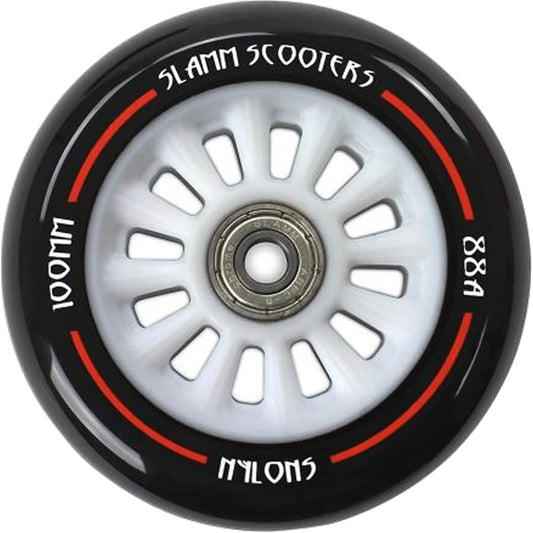 A close-up of the Slamm Nylon Core V2 100mm Scooter Wheel by Slamm showcases a black and white design with red accents, featuring "100mm," "88A," and "Nylon" markings. The central metal hub contains ABEC 9 Chrome Bearings, highlighting its durability, while the polyurethane composite guarantees a smooth ride.