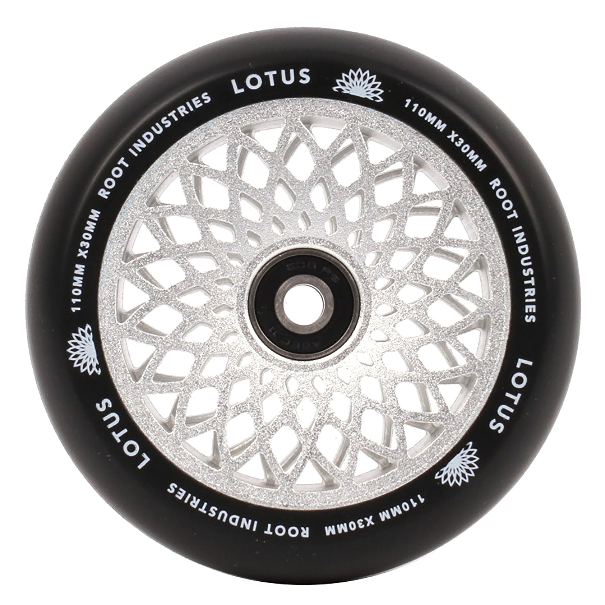 A detailed look at the Root Industries Lotus 110mm X 30mm Stunt Scooter Wheel showcases its intricate lotus core design. The black rim features "LOTUS" and "ROOT INDUSTRIES," along with the dimensions "110MM X 30MM," making it perfect for freestyle scooter enthusiasts.