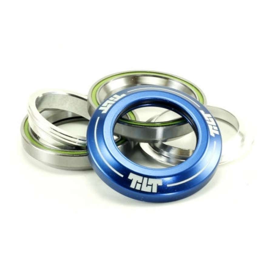 A stack of metal rings features an integrated scooter headset, prominently showcasing the Tilt Integrated Stunt Scooter Headset in blue. The rings include components like dust covers and Campy spec bearings, enhancing durability for scooters or bicycles.