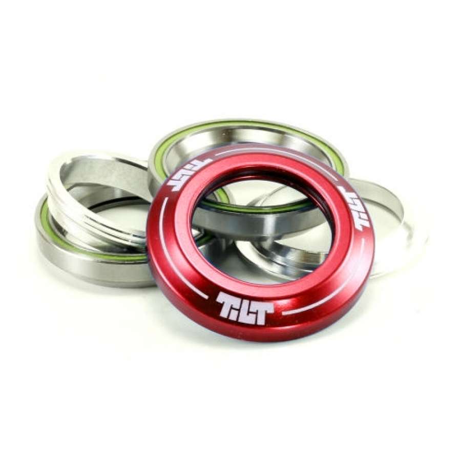 This set, known as the Tilt Integrated Stunt Scooter Headset - Red, includes precision-sealed Campy spec bearings with multiple metallic rings and a distinctive red ring labeled "TILT." The glossy anodized dust covers create a striking contrast with the silver rings.