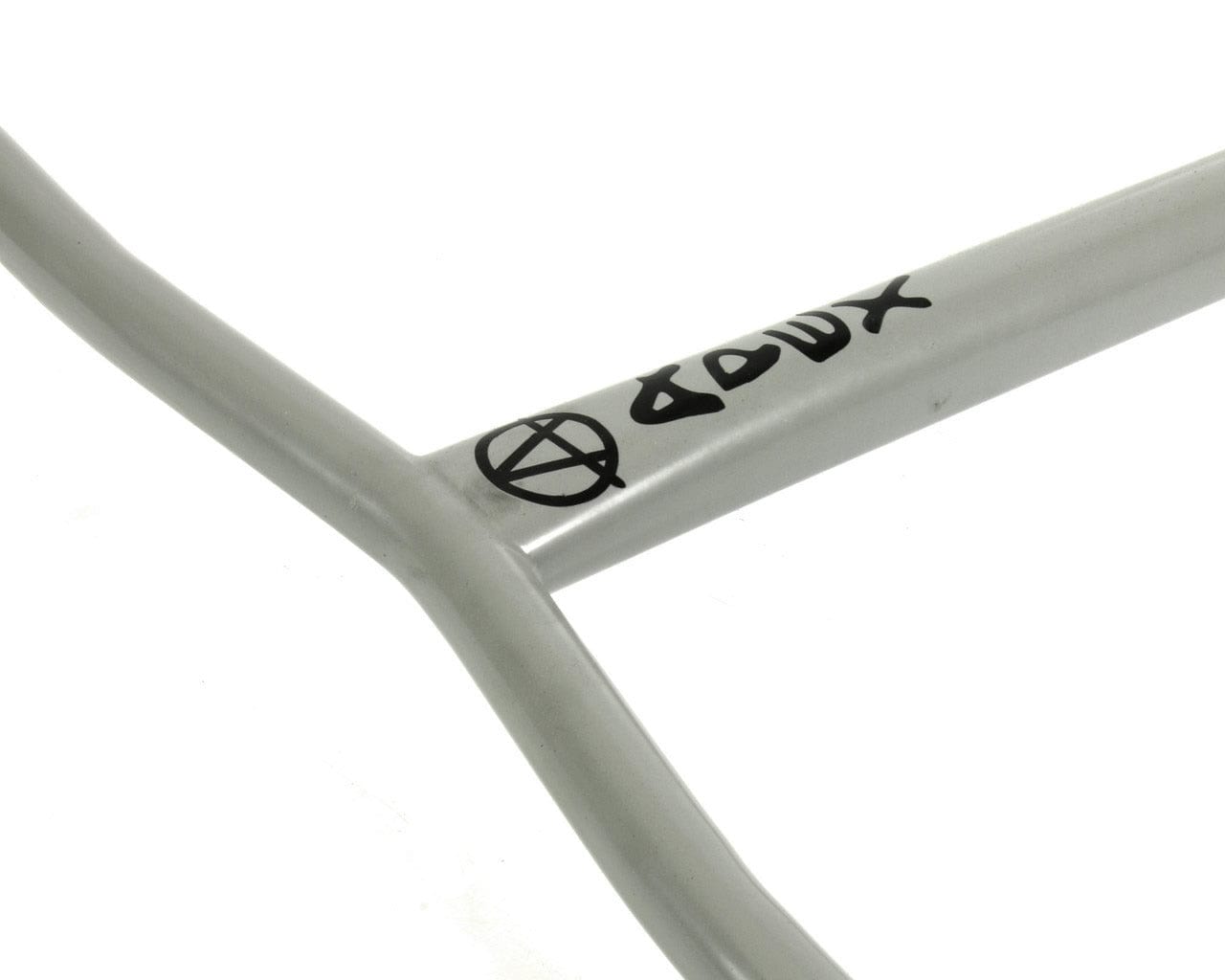 Close-up of a gray Apex Bol steel frame with black graffiti-style text and logo. The Apex Bol oversized HIC stunt scooter bars are designed with angular lines and intersections, boasting a scratch-resistant finish on their 610mm x 560mm dimensions against the white background.