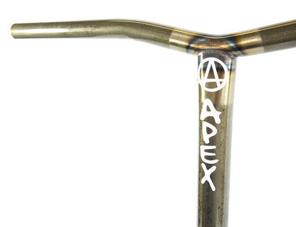 Here is a close-up of the Apex Bol Steel Standard SCS Stunt Scooter Bars in Clear Raw, measuring 590mm x 560mm. These bars feature a sleek metallic finish with the word "APEX" and a circular "A" logo printed in white on their vertical section. Constructed from durable 4130 Chromoly Steel, the handlebar boasts a classic T-shaped structure for optimal control.