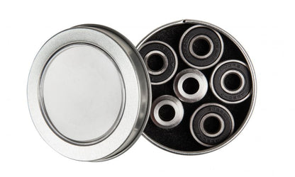 A durable Blazer Pro display tin with a transparent lid is open, revealing four black ABEC 7 scooter bearings arranged inside. The steel-colored bearings fit snugly in a foam insert, showcasing their precision and quality.