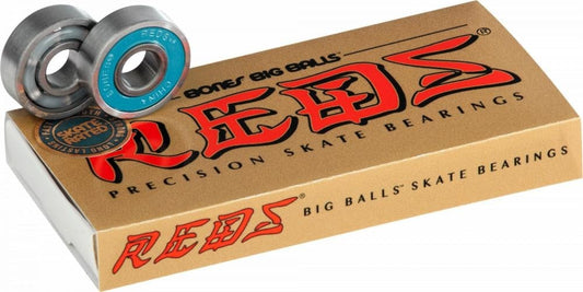 Close-up of a package of Bones REDS Big Balls Skateboard Bearings - 8 Pack, featuring a brown box with bold red and black text. Speed and strength are highlighted by two metal bearings, with one showcasing a blue inner ring, prominently displayed on top.