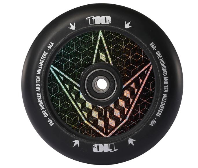 A close-up of a black scooter wheel highlights Blunt Envy's 110mm Hollow Core Stunt Scooter Wheel, adorned with a Geo Logo Hologram. It features their innovative hollowcore technology with a geometric pattern and reflective design. The text reads "110" at the top and "One Hundred and Ten Millimeter - 84A" around the edge, ensuring maximum performance.