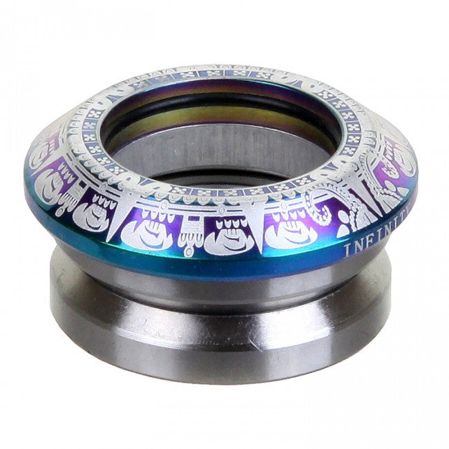 A neochrome object shaped like a yoyo, crafted with intricate patterns using CNC milled aluminum, showcases a shimmering blend of silver, blue, and purple hues. The brand "Infinity" ornaments the side with stylized geometric motifs, reminiscent of the high-performance design found in their Mayan Integrated Stunt Scooter Headset.