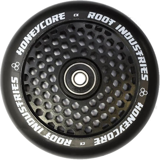 A detailed view of the black wheel from the Root Industries Honeycore 120mm Stunt Scooter, showcasing its unique honeycomb design and prominently displaying "Root Industries Honeycore" along the edge. This wheel, paired with top-tier Root bearings, is designed for smooth rides and exceptional durability.