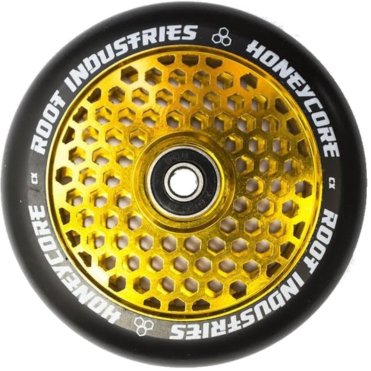 The Root Industries Honeycore 110mm Stunt Scooter Wheel - Black / Gold boasts a bold black outer rim coupled with an eye-catching gold honeycomb design at its core. The phrase "ROOT INDUSTRIES HONEYCORE" is stylishly inscribed around the edge, enhancing the look of any scooter.