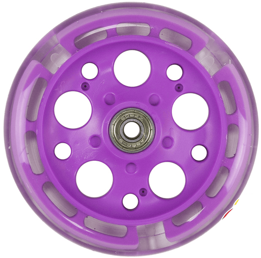 A close-up of the Zycom 125mm Light Up Front Scooter Wheel - Purple showcases a transparent outer edge. This purple wheel is designed with multiple circular cutouts surrounding a central metallic bearing for attachment.