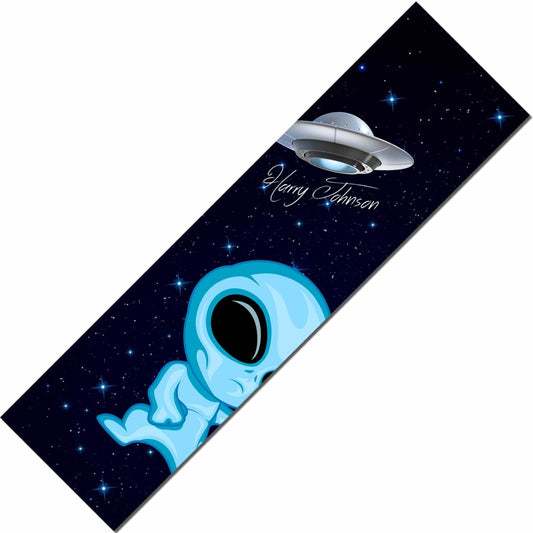 A bookmark showcasing a small blue alien with large black eyes under a starry sky, alongside a hovering flying saucer featuring "Henry Johnson" in script. It's akin to discovering Skates.co.uk's Signature Stunt Scooter Griptape—Harry Johnson edition, delivering unmatched rider control that's both unique and personalized.