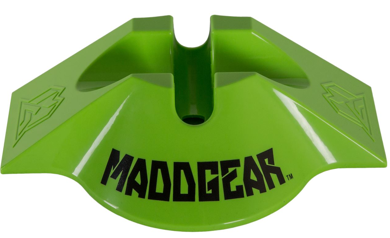 The Madd Gear MGP Scooter Stand V2 in Lime safely stores your scooter and features "MADDGEAR" printed in black on the front. This durable stand boasts a unique angular design with small geometric patterns on each side.