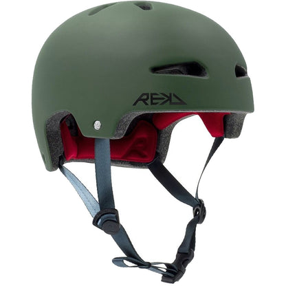 Introducing the REKD Ultralite In-Mold Skate / Scooter Helmet in Green, a striking blend of matte green and a sleek black logo, designed for action sports enthusiasts. This helmet features multiple ventilation holes and a vibrant red interior lining. It is lightweight with adjustable black straps and a secure buckle, making it perfect for cycling or skateboarding adventures.