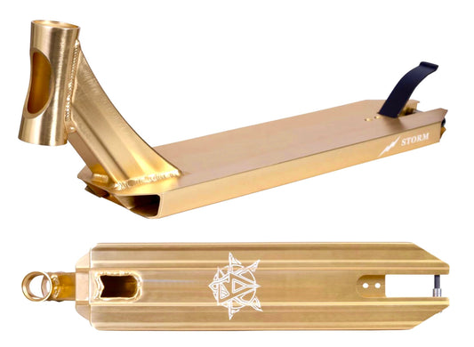 The Revolution Storm Gold Chrome Stunt Scooter Deck, measuring 4.7" x 19", features a gold-colored deck with a prominent head tube displaying the Revolution logo. Geometric patterns adorn the underside, making it ideal for park enthusiasts. It includes a black brake and offers comprehensive views from both side and top angles for an all-encompassing look at this stylish scooter deck.