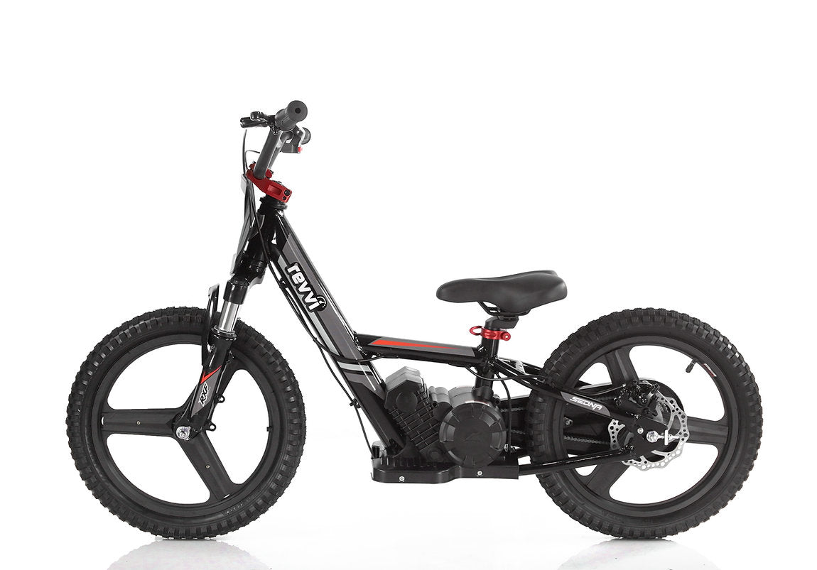 The Revvi 16" Plus Kids Electric Balance Bike in black is perfect for young adventurers. It boasts thick tires, a compact frame, and a low seat similar to the TEWI electric trial bike. With a small motor and red accents on the handlebars and frame, it makes an ideal kids' electric bike for off-road fun.