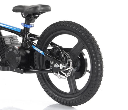 A close-up of the Revvi 16" Plus Kids Electric Balance Bike - Blue showcases its black and blue design, complete with a thick, treaded rear tire fitted with a disc brake. The frame displays visible wiring and houses a battery pack above the wheel. The seat is strategically placed above the rear end, making it an ideal choice for young riders.