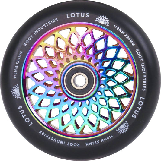 The Root Industries Lotus 110mm Scooter Wheel - Neochrome Rocket Fuel showcases a vibrant core with metallic rainbow hues, paired with a black tire. Designed for freestyle scootering, the geometric pattern on the inner core resembles a lotus flower and features "LOTUS" along with "ROOT INDUSTRIES" on the tire.