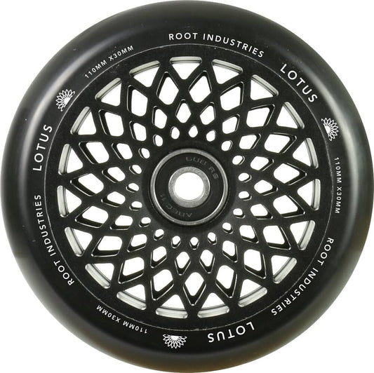 The Root Industries Lotus 110mm Scooter Wheel - Black boasts a sophisticated black color with a circular design, ideal for freestyle scootering. The innovative lotus core increases durability while adding an elegant touch to your ride.