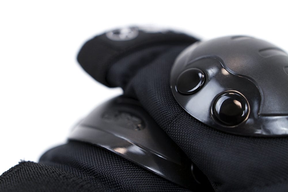 Close-up of the protective glove from the SFR Youth Ramp Triple Skate Protection Pad Set in black, featuring shiny hard-shell knuckle guards. The glove's texture and stitching emphasize its sturdy construction, making it perfect for young skateboarders. The background is plain white.