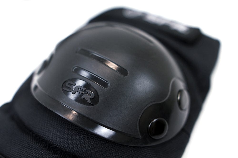 Close-up of a knee pad from the SFR Youth Ramp Triple Skate Protection Pad Set in black, featuring a hard plastic shell marked with "SFR." It's designed specifically for skateboarders and includes two ventilation slits and durable black fabric, making it ideal for youth ramp protection.