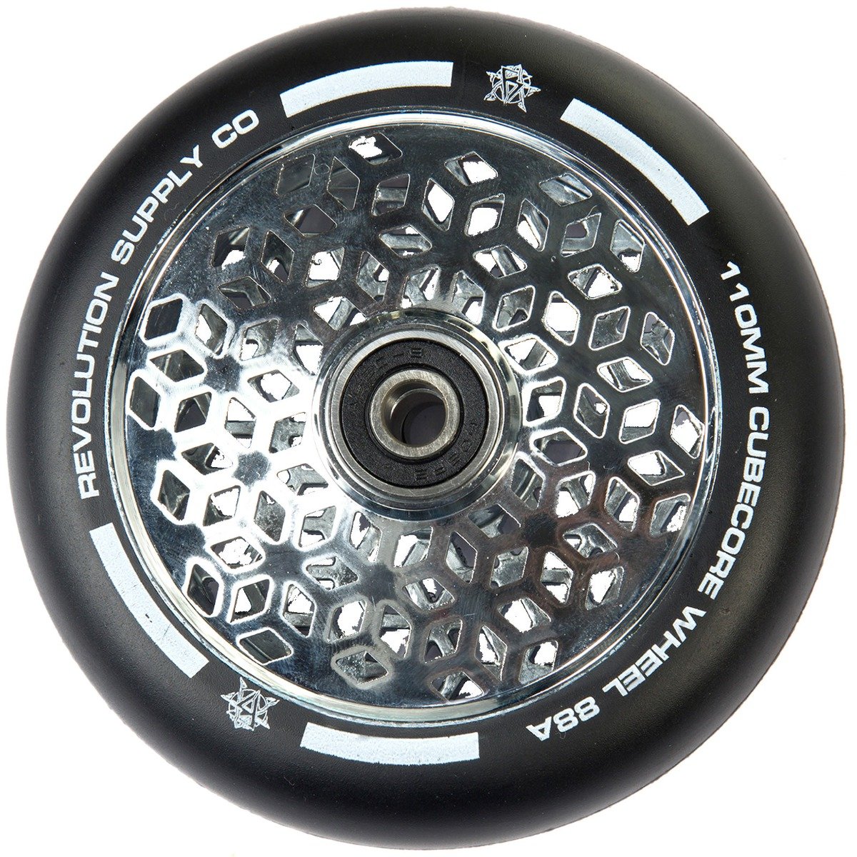 A close-up of the Revolution Cubed Core Ultralite 110mm Stunt Scooter Wheel by Revolution highlights its advanced design with Ultralite Cube Core Technology. The wheel boasts a sleek black exterior complemented by a chrome silver hexagonal core and central bearing, epitomizing cutting-edge scooter wheel design.