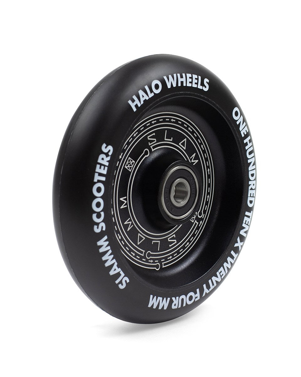 The Slamm Halo Deep Dish 110mm Stunt Scooter Wheel in black features white text around the rim, displaying "Slamm Halo Wheels," "Slamm Scooters," and "One Hundred Ten x Twenty Four MM." This scooter wheel includes a metallic center bearing, perfect for those seeking high-performance 110mm wheels.