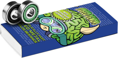 A package of Speed Demons ABEC 5 Brainiac Skateboard Bearings - 8 Pack features a vibrant cartoon character with a green brain design, symbolizing the exhilarating experience of skateboarding. Two ABEC 5 Bearings prominently displayed highlight the assurance of exceptional speed and performance.