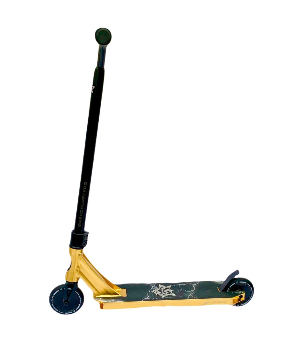 The Revolution Storm Complete Stunt Scooter - Gold Chrome from Revolution stands upright with its T-shaped handlebar. The deck showcases an eye-catching graphic design, and the compact, dark wheels ensure smooth gliding. Its lightweight and sleek build offers a modern look ideal for the skatepark.