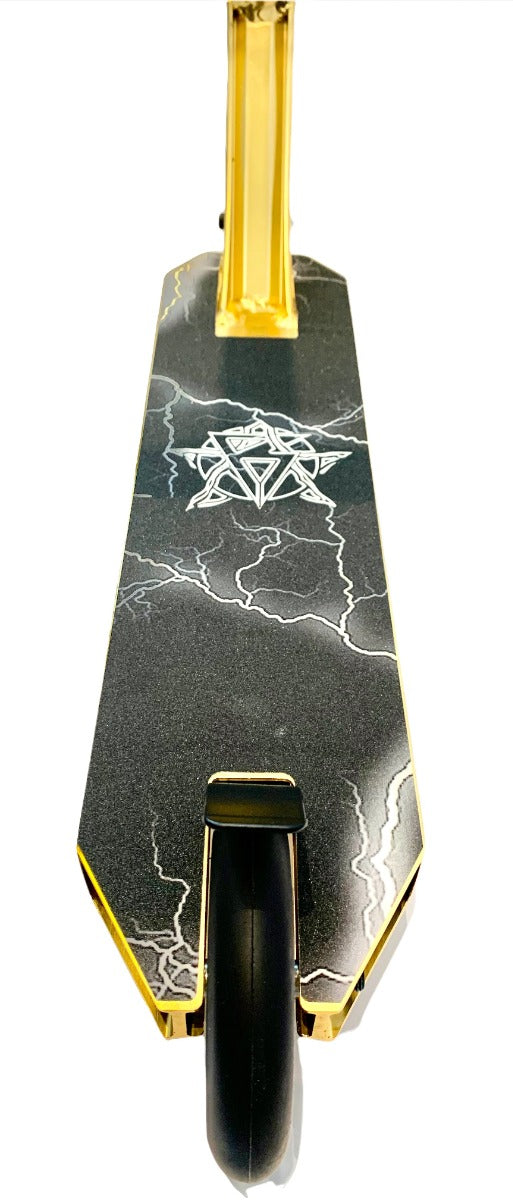 A close-up view of the Revolution Storm Complete Stunt Scooter - Gold Chrome deck highlights its black and gray marble-like design adorned with thin white lightning patterns and a geometric emblem. Ideal for the skatepark, this scooter boasts a black wheel and gold-colored sides.