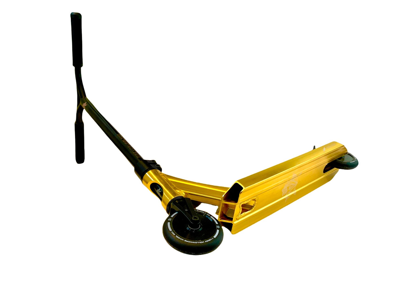 The Revolution Storm Complete Stunt Scooter in Gold Chrome, featuring a wide deck and handlebars with two wheels, is displayed against a white background. This lightweight scooter is tilted to highlight its design and details, making it ideal for skatepark adventures.