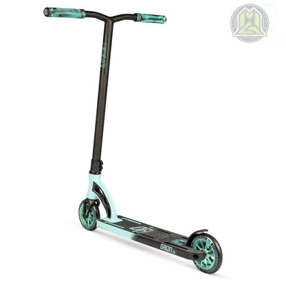 The Madd Gear (MGP) VX Origin Pro Complete Stunt Scooter is a dynamic teal blue and black model, characterized by its T-shaped handlebar and durable design. It features two wheels with teal rims and a deck adorned with graphics prominently displaying the word "Origin.