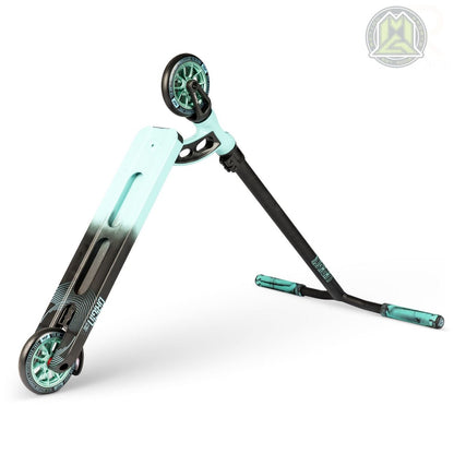 A teal blue and black Madd Gear (MGP) VX Origin Pro Complete Stunt Scooter is folded for transport. It showcases a modern design with branding on the deck and handle, featuring two wheels and a compact frame against a plain white background, highlighting the scooter's sleek appearance.