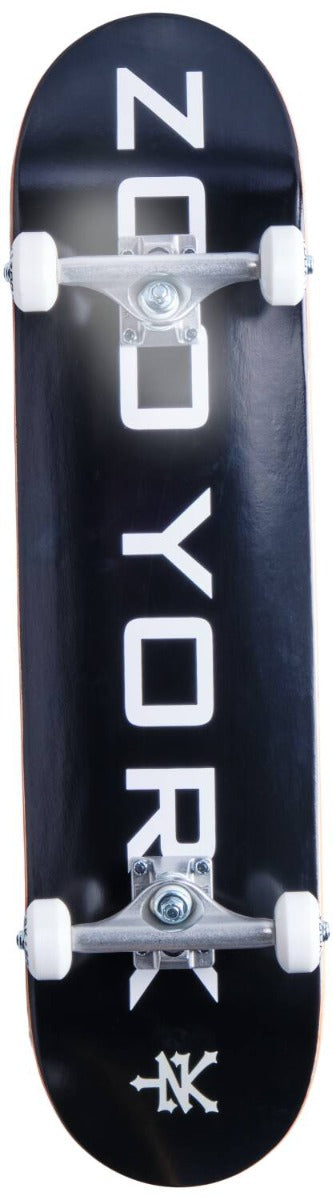 A Zoo York Logo Block Black/White Complete Skateboard, measuring 8" x 31.5", featuring a 7-ply hard rock maple deck with a double kick-tail, black surface, and white wheels and trucks, prominently displaying "ZOO YORK" in bold white letters.